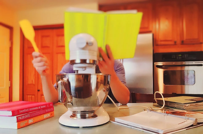 Person learning to cook in kitchen.