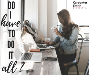 A woman works at a desk alone